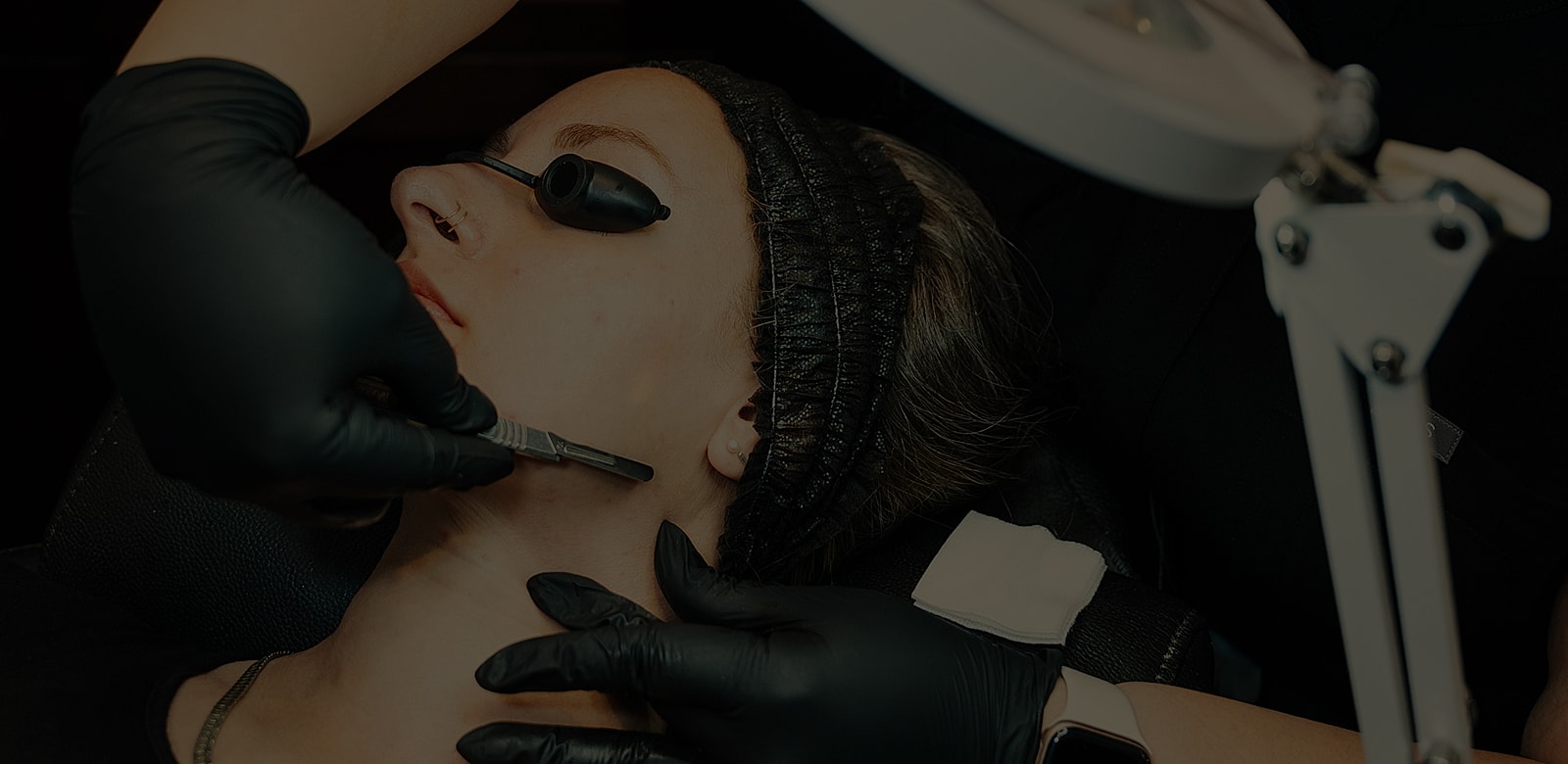 Person receiving a skincare treatment in salon.