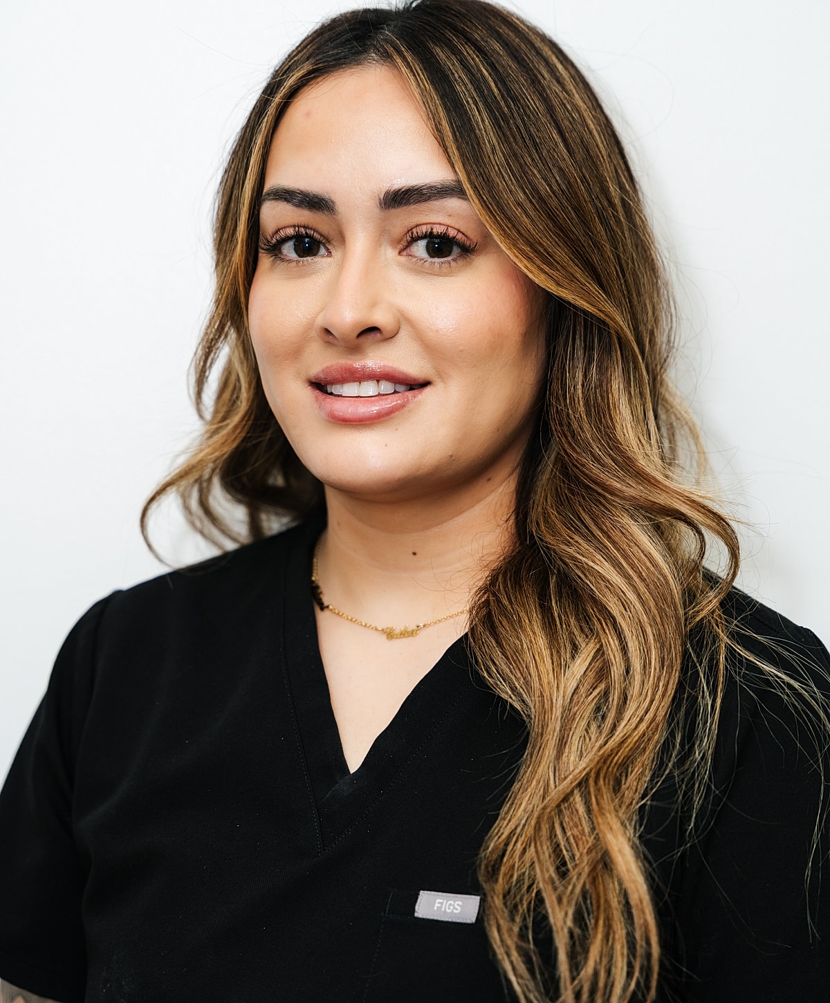 Smiling woman with long hair against a textured background.