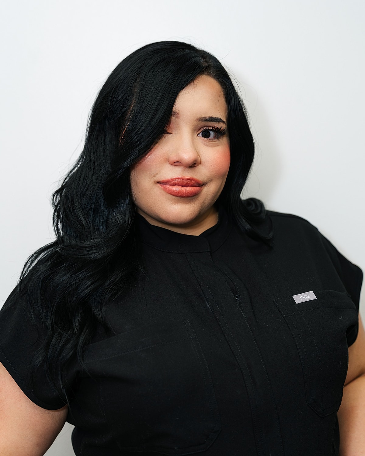 Woman with long dark hair, black shirt.