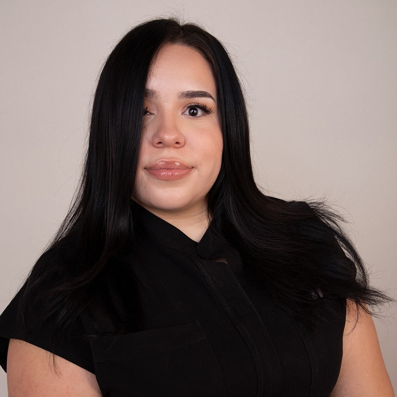 Woman with long dark hair, black shirt.