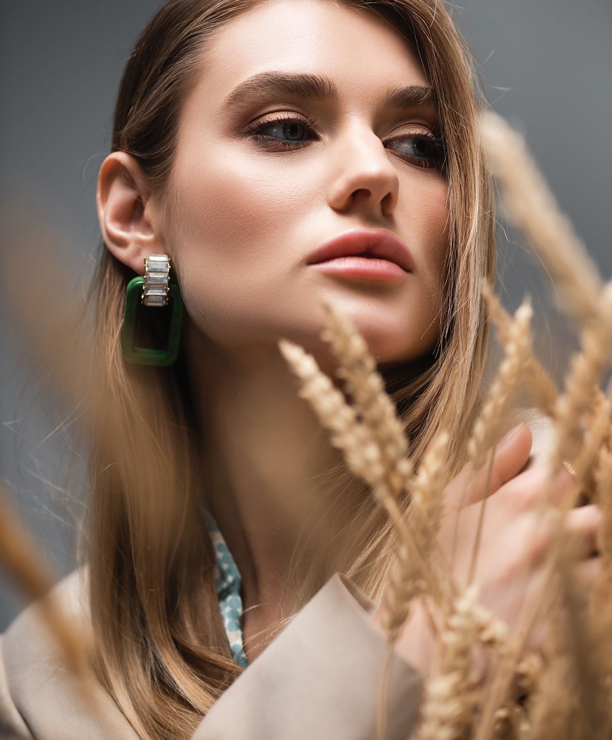 Hyaluronidase model with earrings and wheat background.