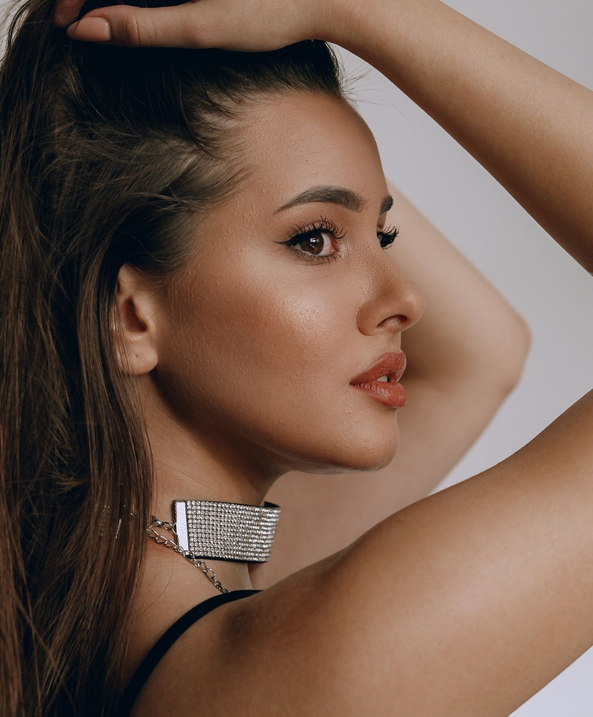 Profile shot of a woman with stylish accessories.