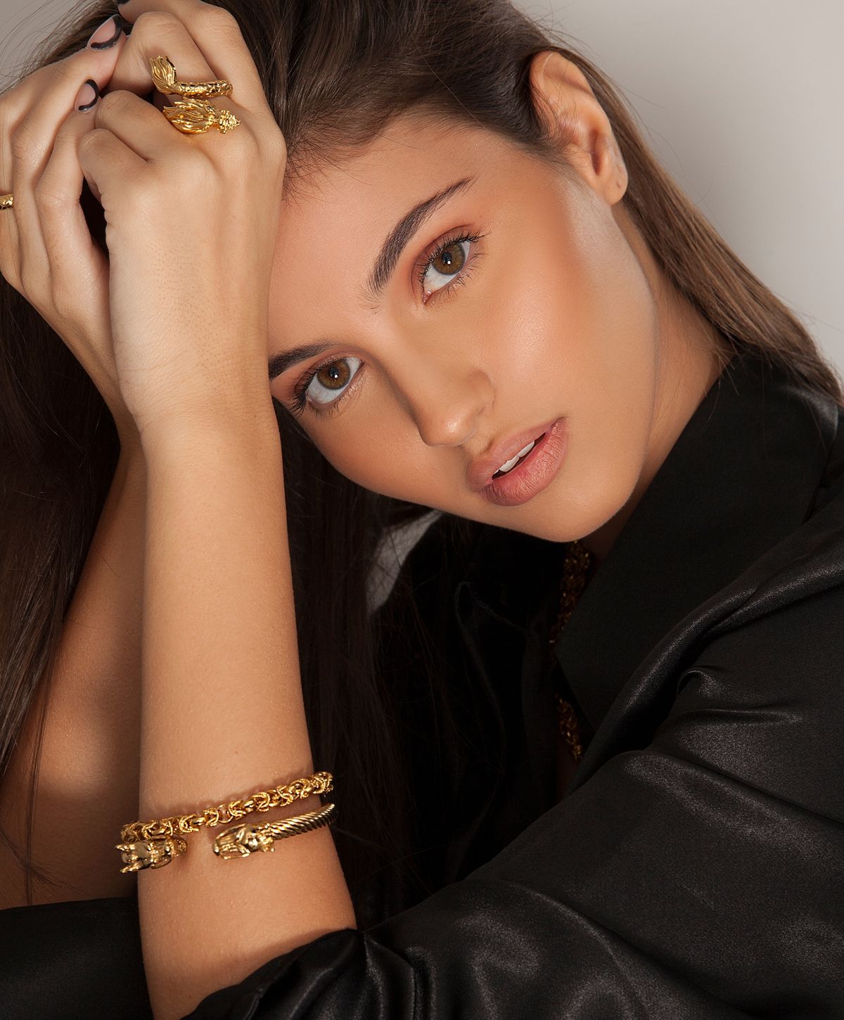 Model showcasing jewelry with a stylish expression.