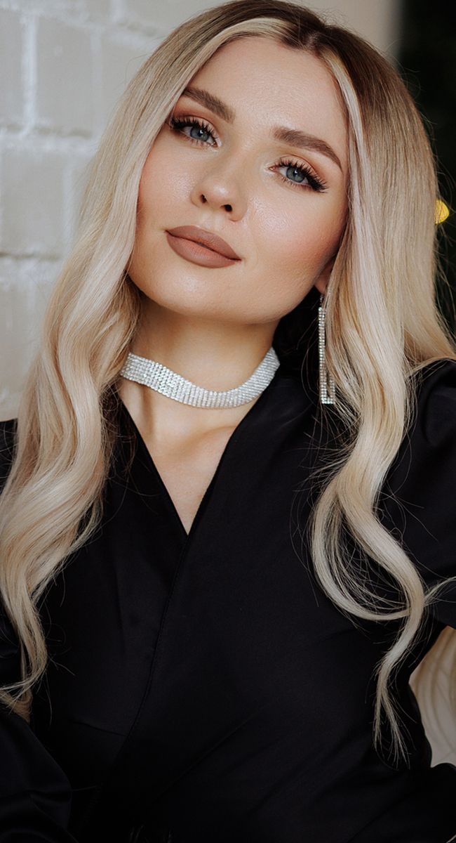 Woman with long hair and elegant accessories.