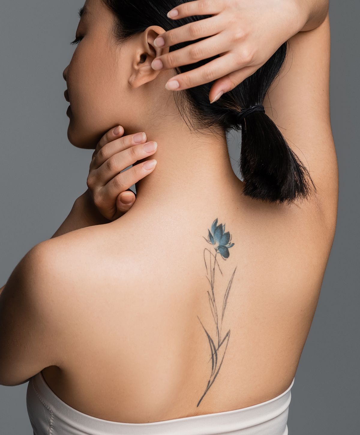 Woman with floral tattoo on her back.
