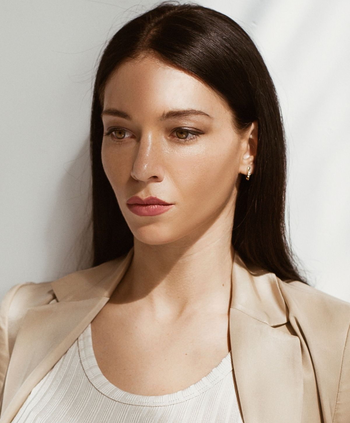 Santa Fe Ultherapy model in a stylish blazer, thoughtful expression.