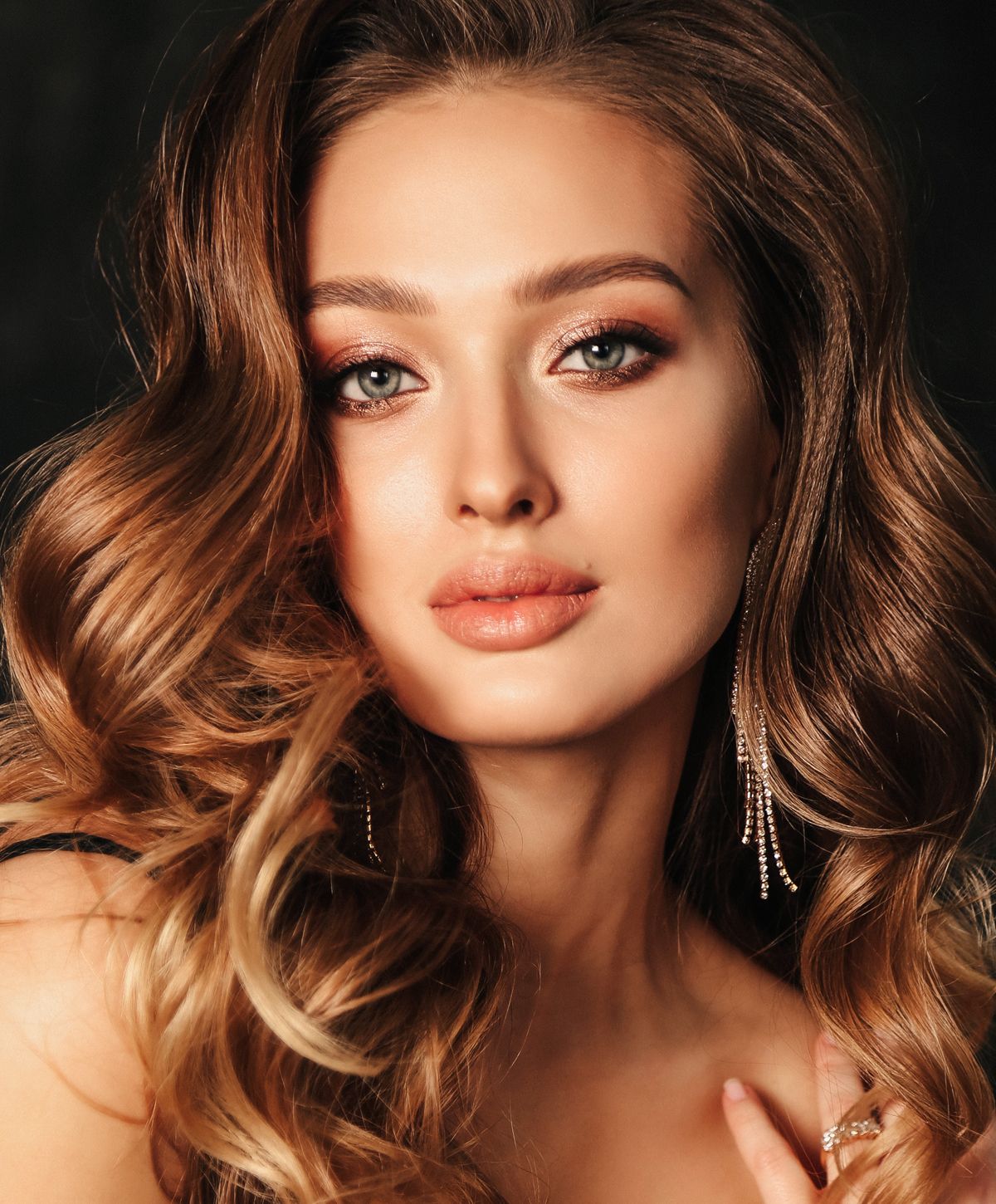 Elegant portrait of a woman with wavy hair.