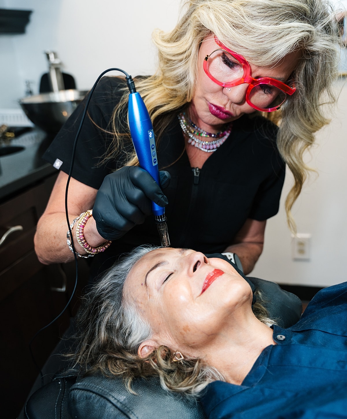 Beauty treatment session with client in salon.