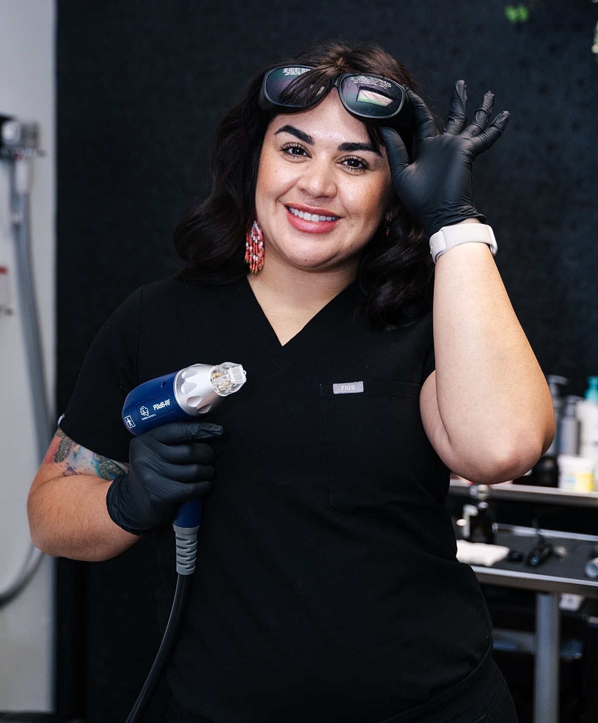 Professional with laser tool and protective goggles.