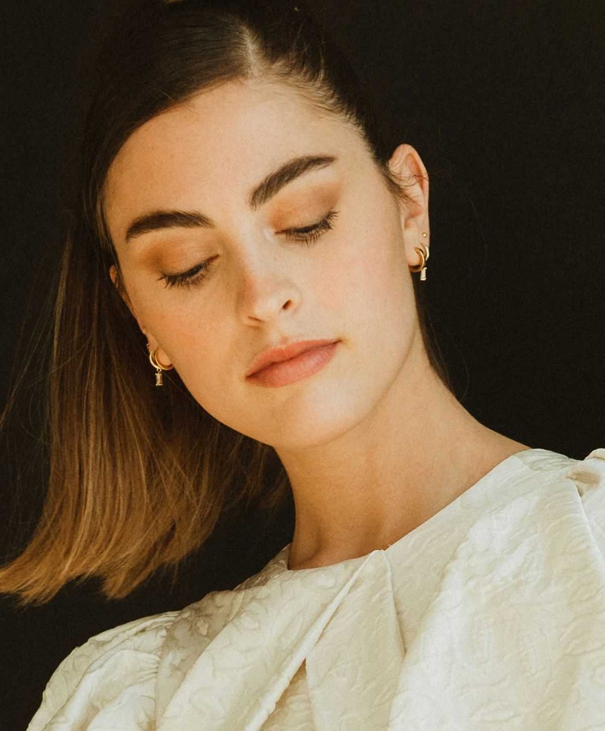 Woman with elegant hairstyle and makeup.