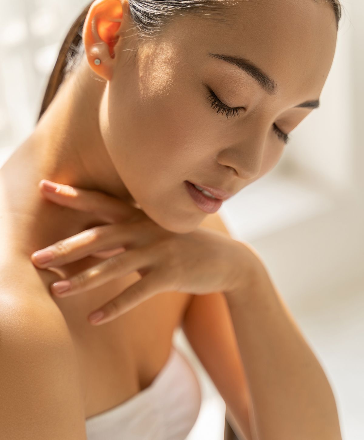 Woman with closed eyes and graceful pose.