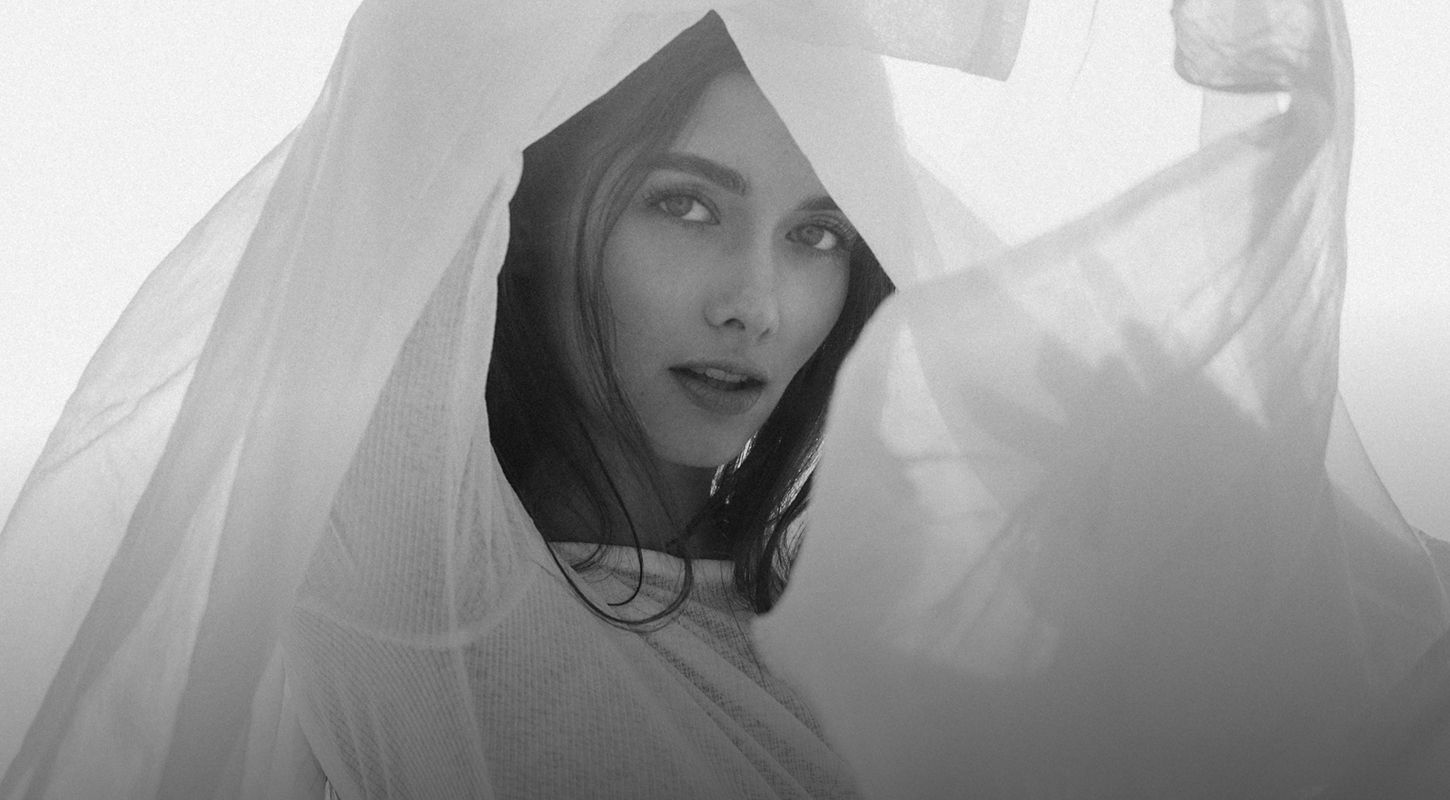 Woman with flowing fabric in black and white.