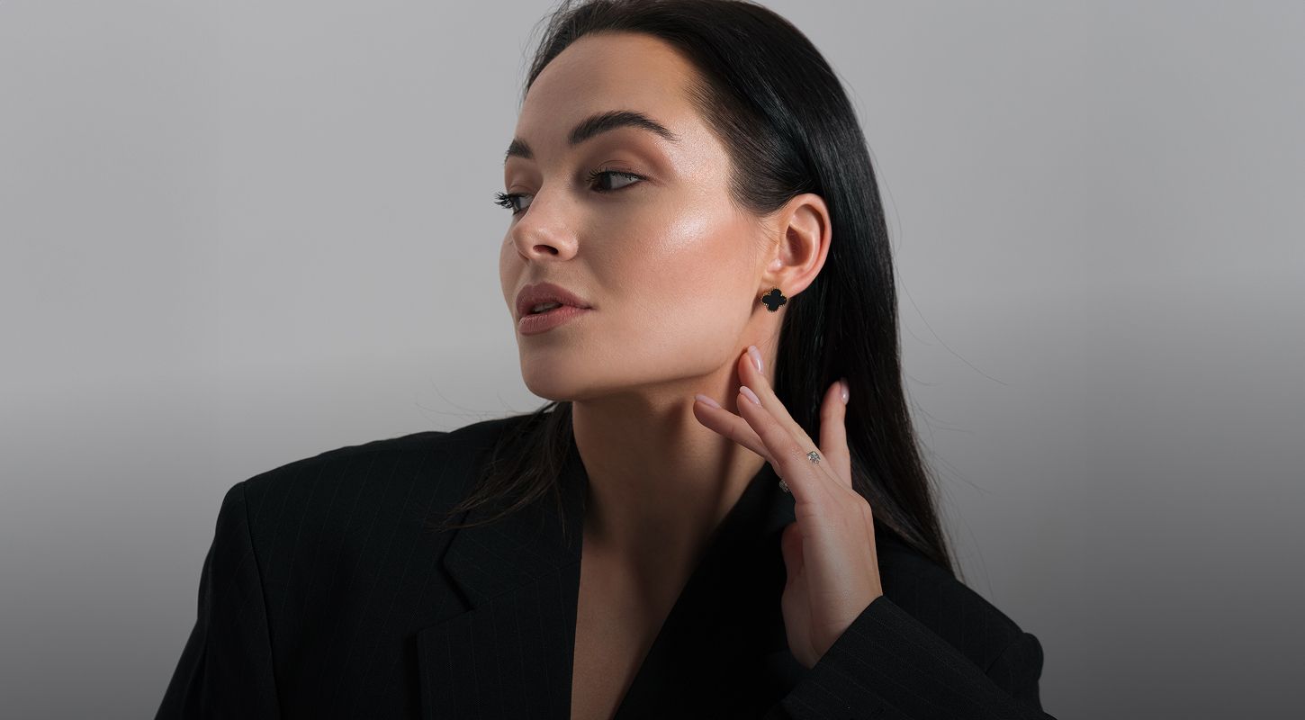 Woman in black blazer with elegant hairstyle.
