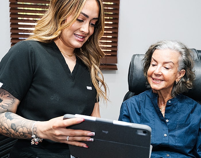 Healthcare professional assisting an elderly patient.