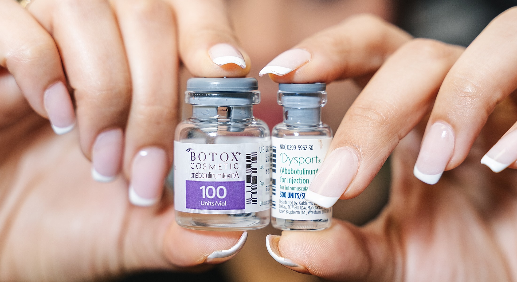 Vials of Botox and Dysport treatments held, for Santa Fe Botox treatments.