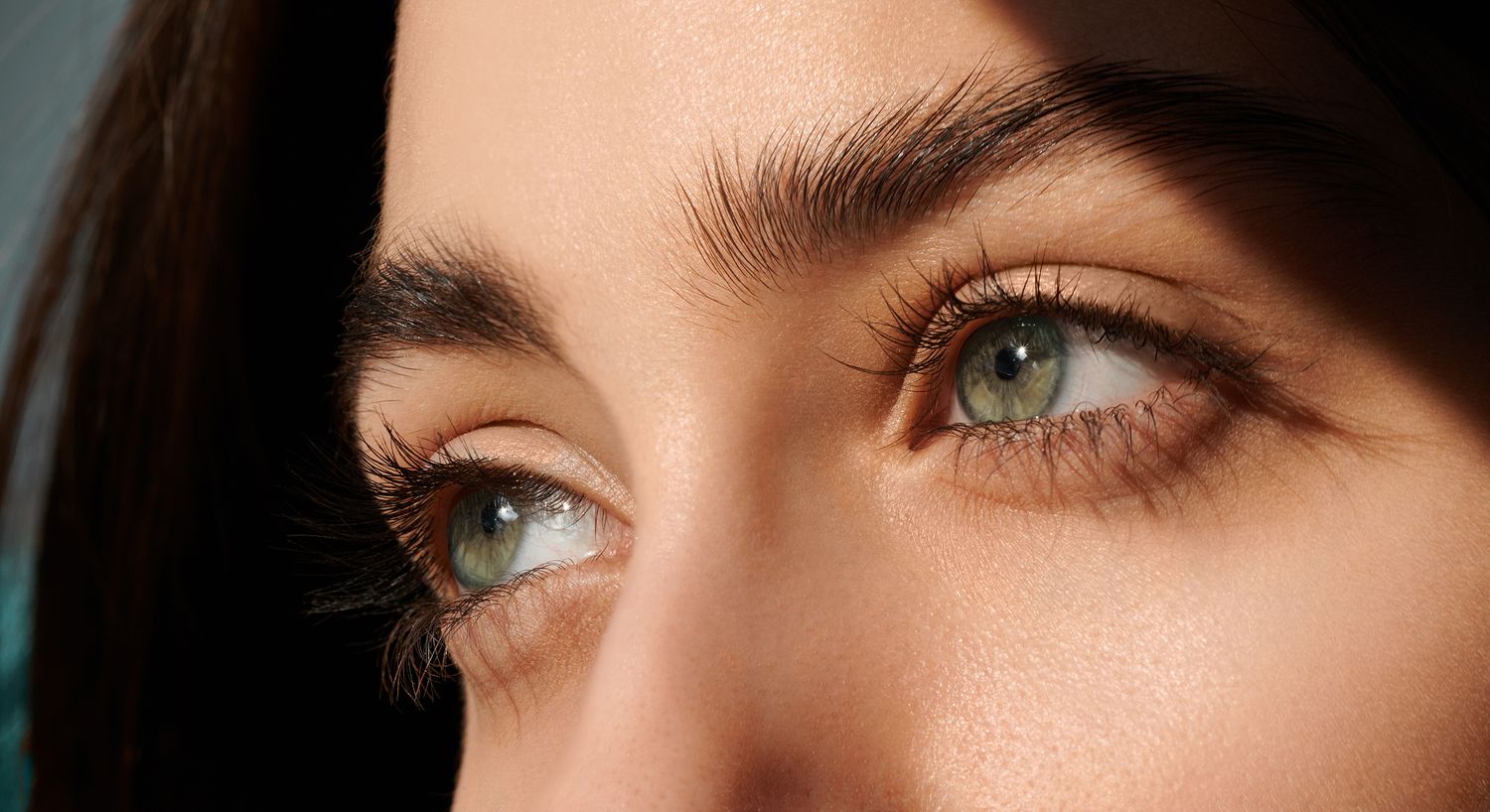 Close-up of striking green eyes and eyelashes, Santa Fe Latisse model.