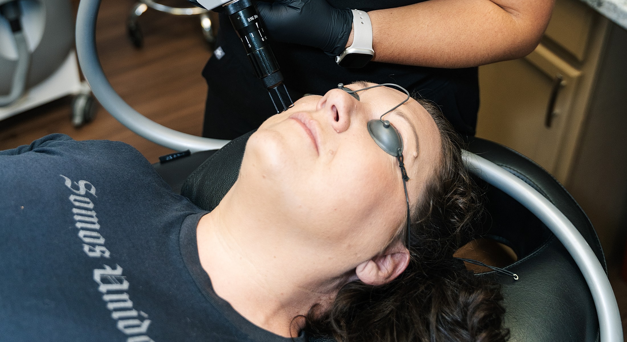 Woman receiving facial treatment in spa setting.