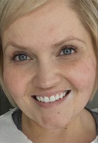 Smiling woman with blonde hair and blue eyes.