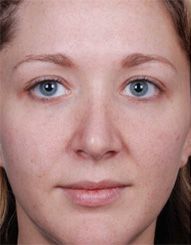 Woman with natural facial features and light makeup.